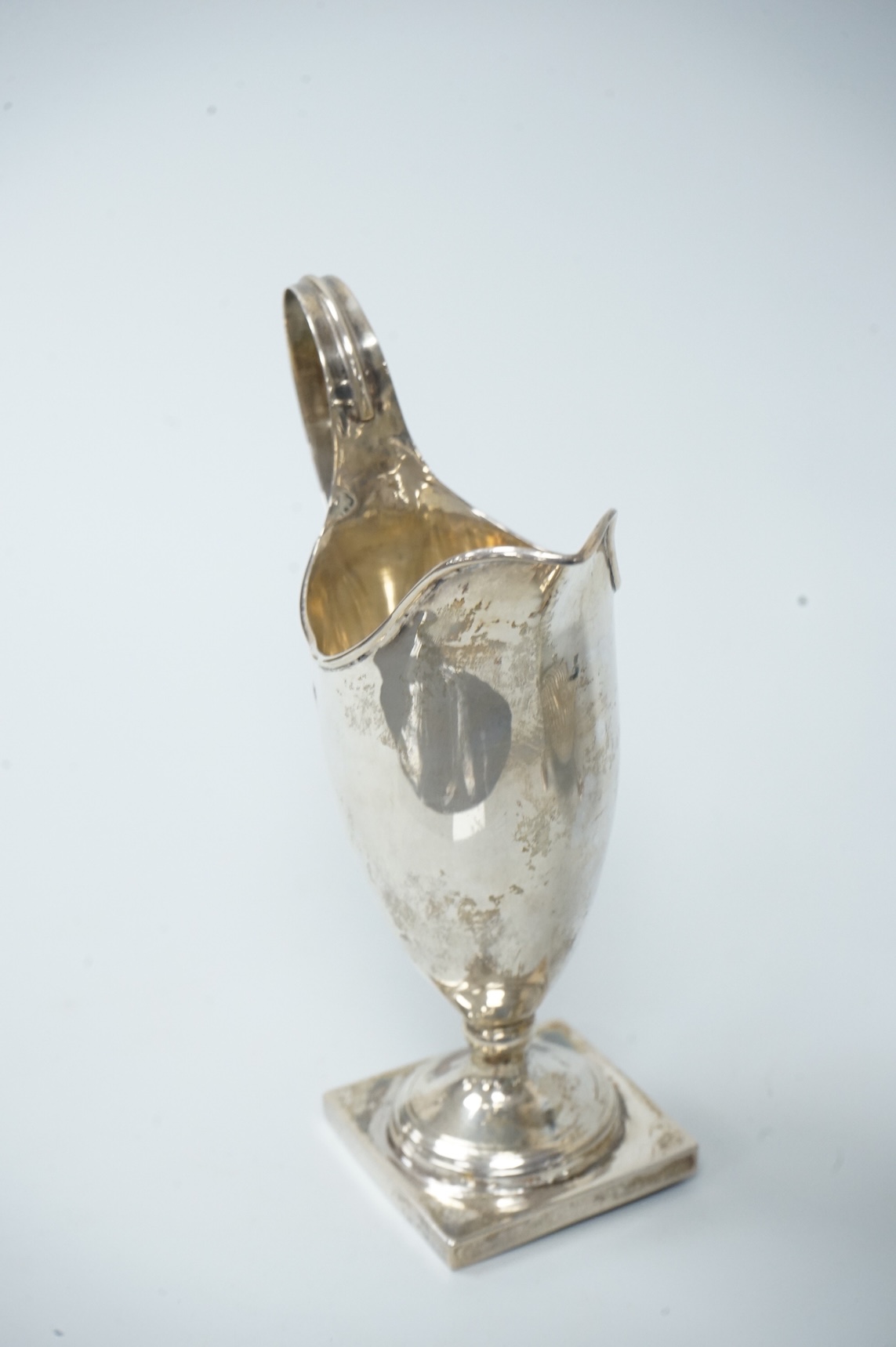 A late Victorian silver sugar basin, by Robert Harper, London, 1879, diameter 13.2cm, together with an Edwardian silver helmet shaped cream jug, Saunders & Shepherd, Chester, 1905, 15cm, 9.1oz.